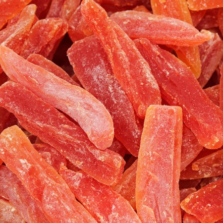 candied sticks of  papaya fruit as background の写真素材