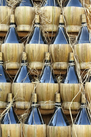 traditional tuscan wine bottles arranged in pyramid ( called fiasco ), Chianti region, Italy, Europeの写真素材