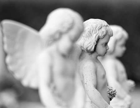 cemetery angel statues with garlands in hands, Italyの写真素材