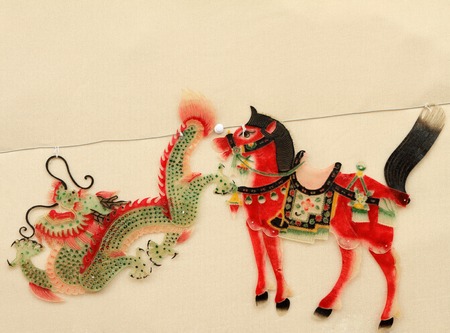 Chinese shadow puppet figures on wall at Liulichang street in Beijing, Chinaの写真素材