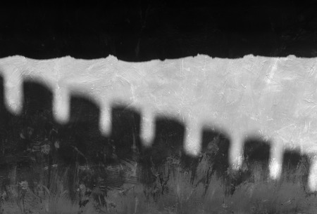 A shaft of sunlight is shining onto gray concrete wallsの写真素材