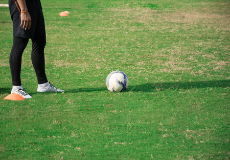 soccer player standing in football field prepare for kick the ball at mid noonの写真素材