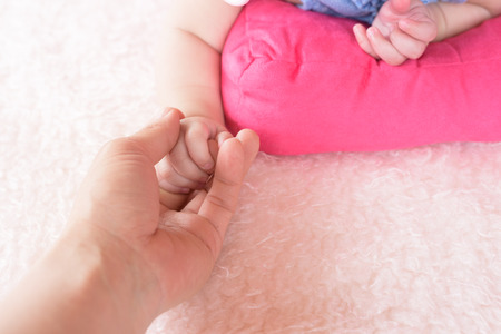 Closed up of mother hand with baby.の写真素材