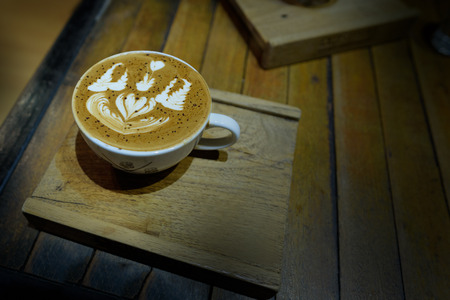 Coffee latte art in coffee shop vintage color tone,vignettingの写真素材
