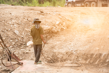 Worker on pontoon hold prestressed concrete wire when pontoon going to stop and let truck move on for move truck to another bank of riverの写真素材