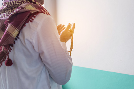 Islam muslim man in custom dress praying in mosque