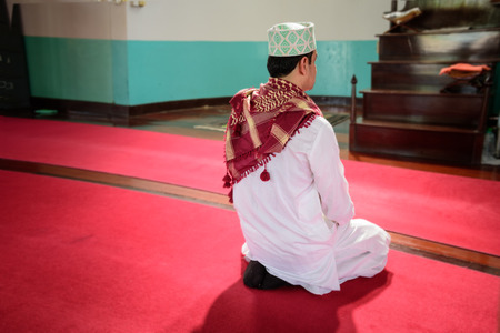 islam muslim man in muslim praying and  sit on red carpet in mosqueの写真素材