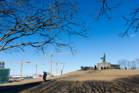 Tourist standing around statue of the old farmstead of Arnarholl stood on the knoll of the same name, where the statue of Ingolfur Arnarson,Iceland first settler around 870 ADの写真素材