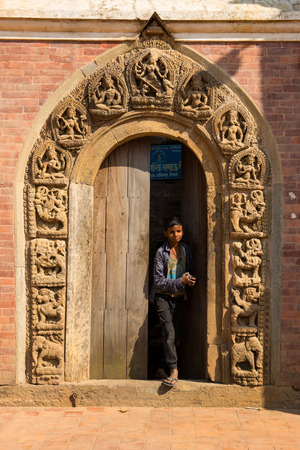 Kathmandu,Nepal -October 16,2018 : Unidentified nepalese boy walk out from door in Patan Duba square in Kathmandu,Nepalのeditorial素材