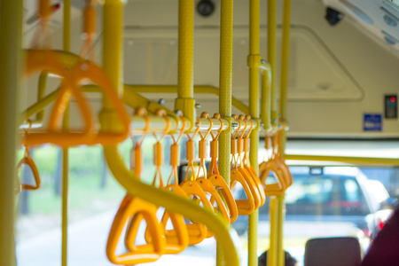 Metropolis. Handrails in a public bus in the photoの写真素材