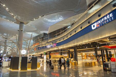 Istanbul,Turkey : 2019 April 16 -  Interior of new Turkish Istanbul airport with passengers and officer and shop and duty fee store.のeditorial素材