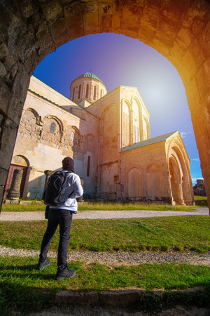 Asian backpacker man traveler at travel destination Bagrati Cathedral in Kutaisi