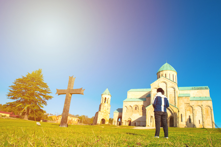 Asian woman girl traveler with local dog  at travel destination Bagrati Cathedral in Kutaisiのeditorial素材