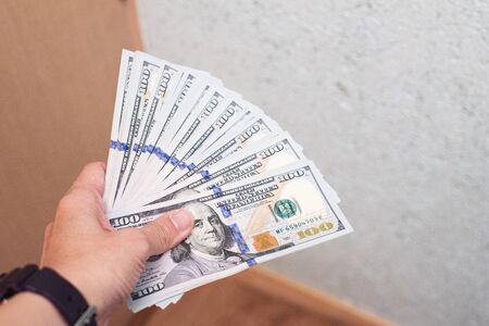 Hand holding dollar banknote money,business and finance concept.の写真素材