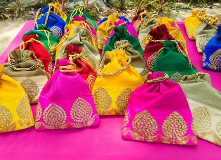 colourful traditional textile handmade souvenir wallet bag decorative with art and craft style arrangement on bazaar market, fashionable needlework gift.の写真素材