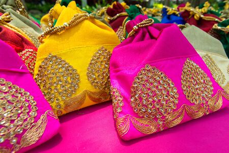 colourful traditional textile handmade souvenir wallet bag decorative with art and craft style arrangement on bazaar market, fashionable needlework gift.の写真素材