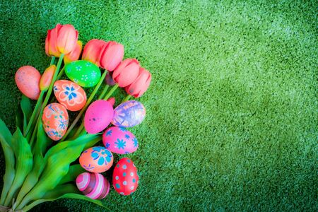Easter eggs painted decoration with colourful on green grass backgroundの写真素材