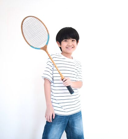 little asian school boy with racket isolated on white background.の写真素材