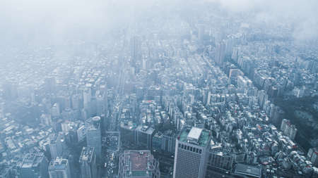 The view across Taipei, captial of Taiwan, from the top of Taipei 101, the second largest building in the world,shoot after raining with fog.のeditorial素材