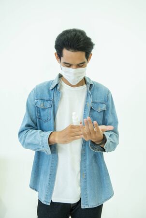 Asian man wash hands antiseptic protect virus or bacteria.patient with mask prevent from corona virus covid-19 isolated on white background.health care and medicine concept.の写真素材