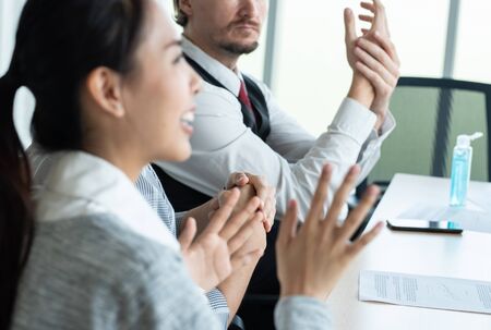 Hand of conference business coworker in workplace rub hand after get sanitizer alcohol gel spray protect from coronavirus or covid-19 virus world pandemic,health care and medicine concept.の写真素材