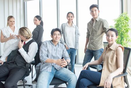 Group of initiative multi-ethnic group young business people sitting in creative modern office, business and financial concept.の写真素材