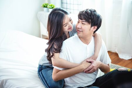 Happy young man and woman hugging embracing indoors. Portrait close up smiling husband and wife...