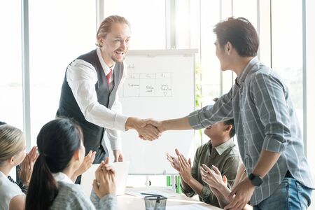 Photo of two multi race person coworkers partnership handshaking celebrating success deal in conference.Successful trade contract after great meeting, business and financial concept.の写真素材
