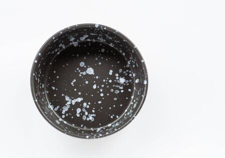 black ceramic bowl isolated on white backgroundの写真素材