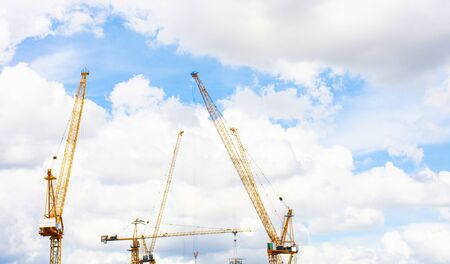 Panorama of crane construction site on background of blue sky and cloud.の写真素材