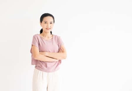 Portrait of beautiful asian young woman with black hair and casual outfit alone in bright lighted room. Background, copy space for text, close up.の写真素材
