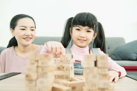 adorbale daugther smile look at mother phone at home.の写真素材