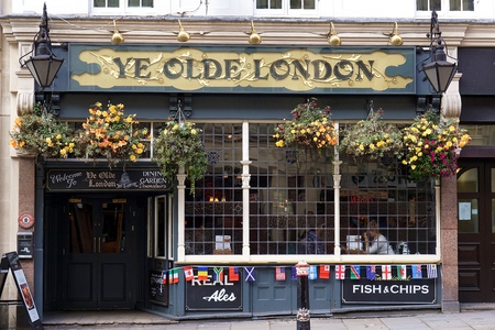 LONDON, UK - OCTOBER 11 2015: People sit in the window-side dining area inside the Ye Olde London, a...