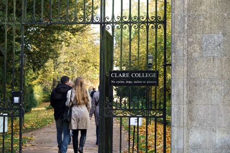 CAMBRIDGE, UK - OCTOBER 31 2015: A couple enters Clare College, Cambridge through its rear entrance...