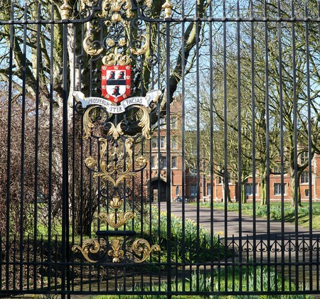CAMBRIDGE, UK - FEBRUARY 16 2016: A coat of arms displaying Jesus College's symbol, the black cockerel, and its Latin motto, Prosperum iter facias May your journey be successful decorates the railings at the Victoria Avenue entrance to the college, in Camのeditorial素材