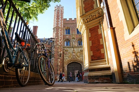CAMBRIDGE, UK - SEPTEMBER 27 2015: Pedestrians pass the entrance gate of St John's College,...