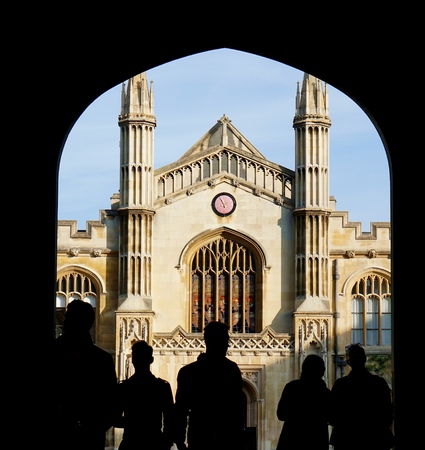 CAMBRIDGE, UK - OCTOBER 31 2015: Silhouetted visitors to Corpus Christi College, University of Cambridge, look through the entrance way arch at the chapel in New Court.のeditorial素材
