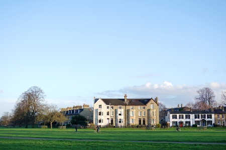 CAMBRIDGE, UK - DECEMBER 8 2015: Cyclists and pedestrians cross Midsummer Common, Cambridge on a...