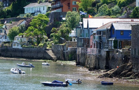DARTMOUTH, UK - JULY 6 2016: Ladders exposed by the low tide lead down to the rocky shore of the estuary of the River Dart in the Devon town of Dartmouth, England.のeditorial素材