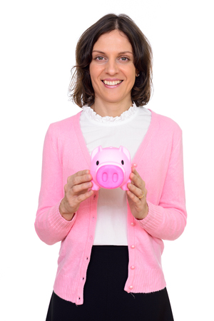 Studio shot of happy Caucasian woman holding piggy bank isolated against white backgroundの写真素材