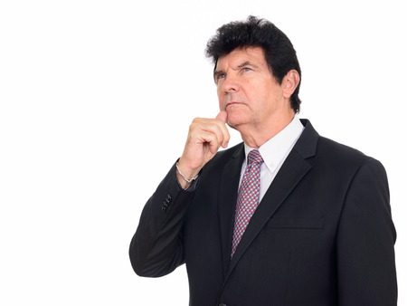 Studio shot of mature Caucasian businessman thinking isolated against white backgroundの写真素材