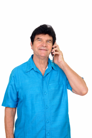 Studio shot of happy  mature Caucasian man talking on mobile phone isolated against white backgroundの写真素材