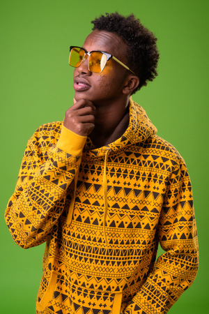 Young African man against green backgroundの写真素材