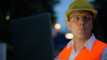 Mature man construction worker at the construction site in the c