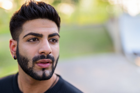 Close up of young handsome Indian man thinkingの写真素材