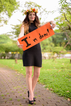 Young beautiful woman celebrating graduation at the park in Bangの写真素材
