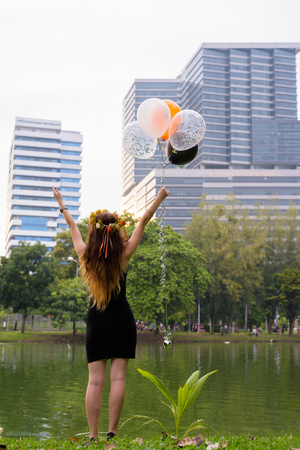Young beautiful woman celebrating graduation at the park in Bangの写真素材