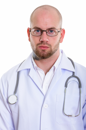 Studio shot of young bald muscular man doctorの写真素材