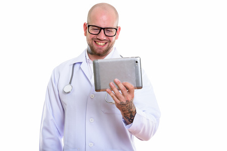 Studio shot of young bald muscular man doctorの写真素材