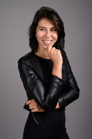 Young beautiful woman against gray backgroundの写真素材